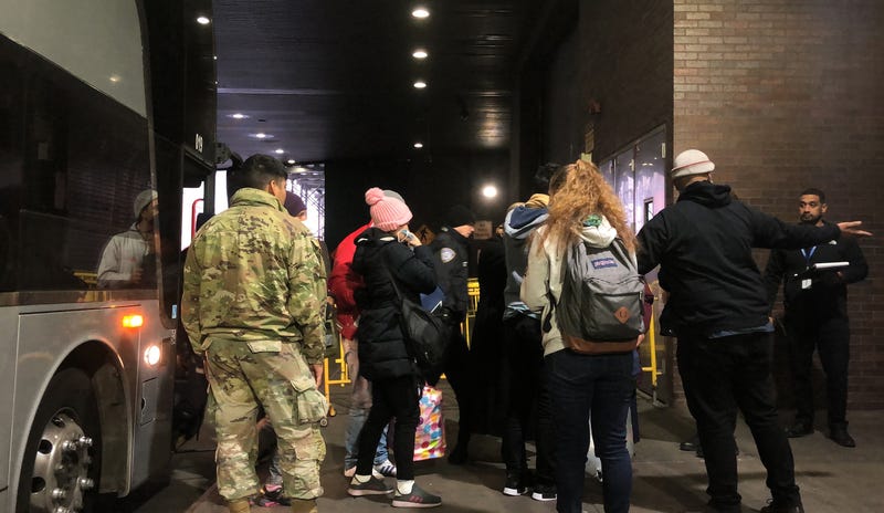 Migrants arriving from Del Rio, Texas, get off a bus at Port Authority in Manhattan on Monday, Dec. 19, 2022.