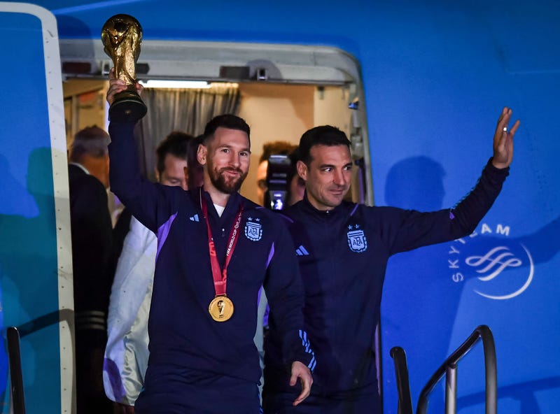 ionel Messi of Argentina (L) and Lionel Scaloni (R) holds the FIFA World Cup during the arrival of the Argentina men's national football team after winning the FIFA World Cup Qatar 2022 on December 20, 2022 in Buenos Aires, Argentina.