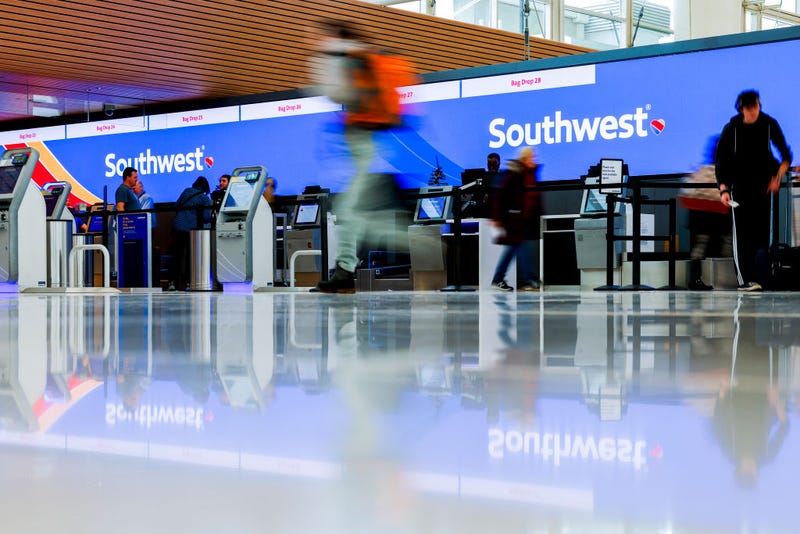 Travelers walk past the Southwest Airlines check-in counter at Denver International Airport on December 28, 2022 in Denver, Colorado.