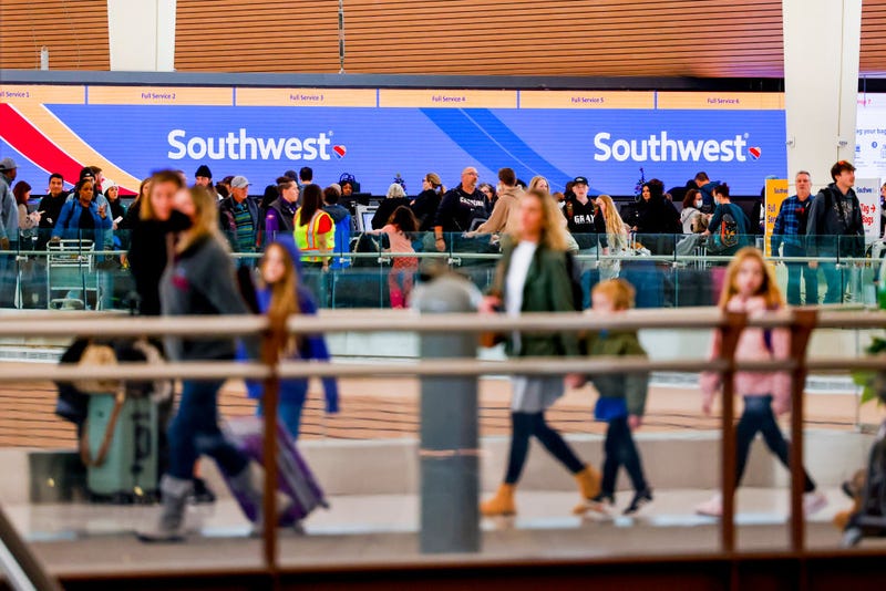 Travelers walk past the Southwest Airlines check-in counter at Denver International Airport on December 28, 2022 in Denver, Colorado.