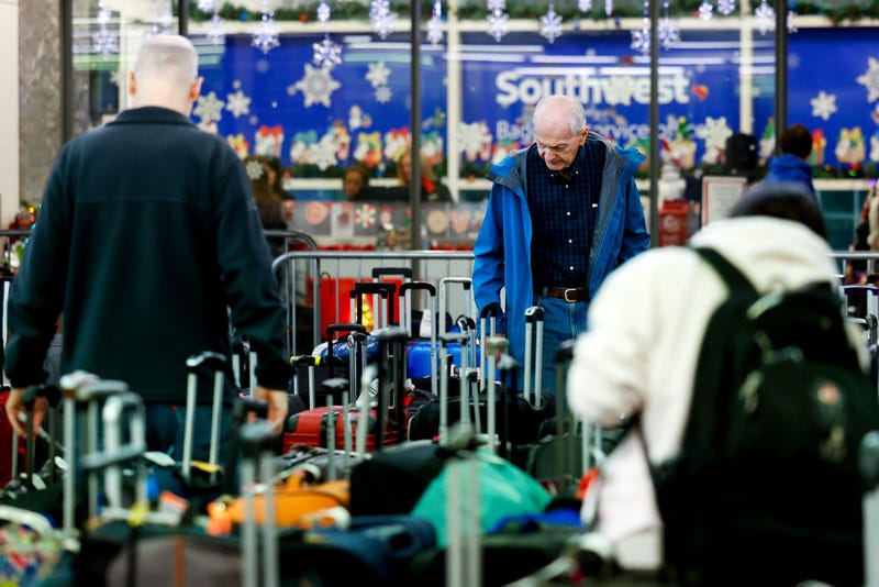 Travelers search for their suitcases in a baggage holding area for Southwest Airlines at Denver International Airport on December 28, 2022 in Denver, Colorado.