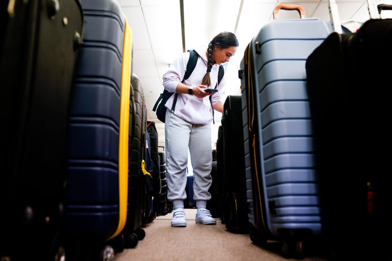 Pristine Floyde searches for a friend's suitcase in a baggage holding area for Southwest Airlines at Denver International Airport on Dec. 28, 2022, in Denver, Colorado. 