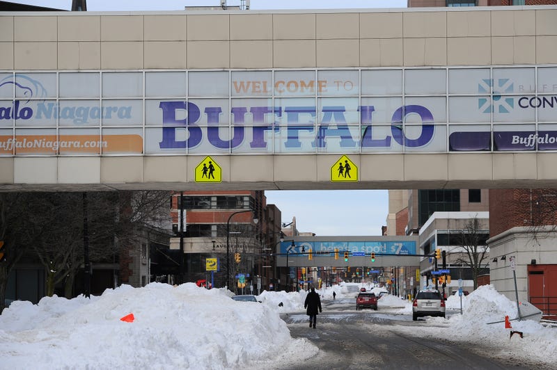 Pedestrians walk in downtown Buffalo during a snowstorm. Despite its propensity for blizzards, the city's home prices and good commutes helped it score the #1 spot
