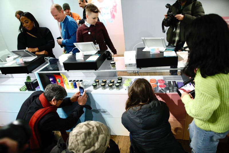 Members of the media take pictures before a press conference at the Housing Works Cannabis Company during the opening of the first legal cannabis dispensary in New York City on Dec. 29, 2022