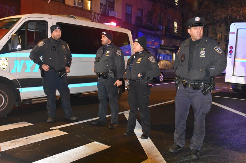 NYPD officers stand guard after three fellow officers were attacked with a machete near Times Square on Dec. 31, 2022