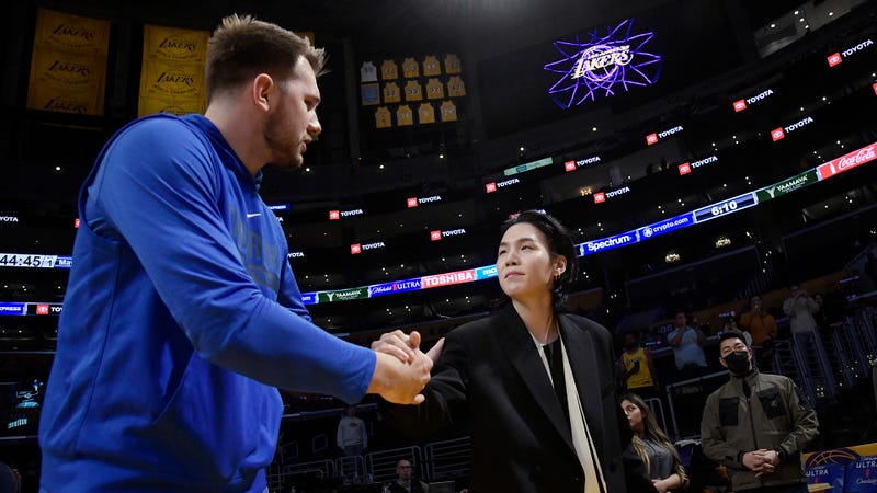 Luka Doncic #77 of the Dallas Mavericks with Suga of BTS