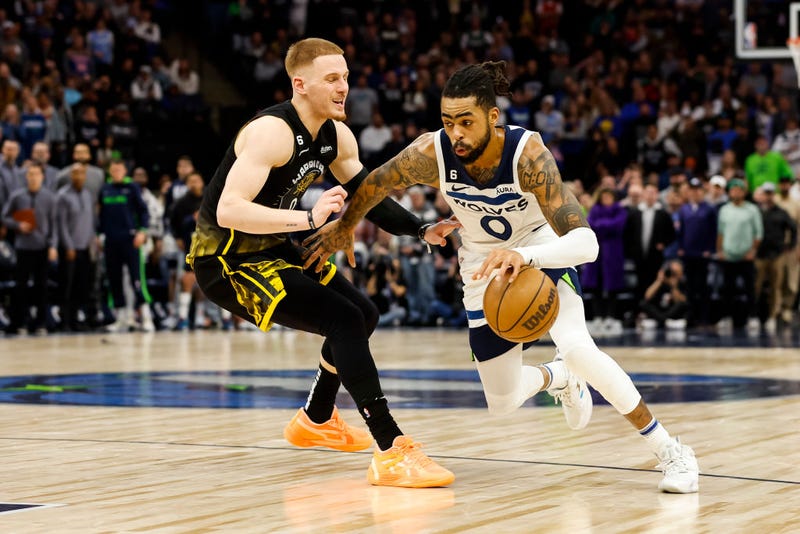 D'Angelo Russell #0 of the Minnesota Timberwolves drives to the basket while Donte DiVincenzo #0 of the Golden State Warriors defends in the fourth quarter of the game at Target Center on February 01, 2023 in Minneapolis, Minnesota.