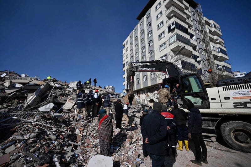Rescuers carry out searches through the rubble of a collapsed building in the southeastern Turkish city of Kahramanmaras, on February 8, 2023