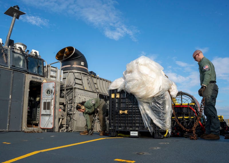 In this U.S. Navy handout, Sailors assigned to Assault Craft Unit 4 prepare material recovered in the Atlantic Ocean from a high-altitude balloon for transport to federal agents at Joint Expeditionary Base Little Creek Feb. 10, 2023. 