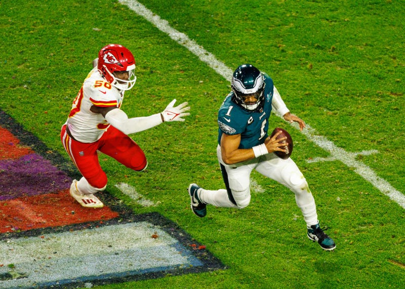 Jalen Hurts and member of Kansas City Chiefs playing football