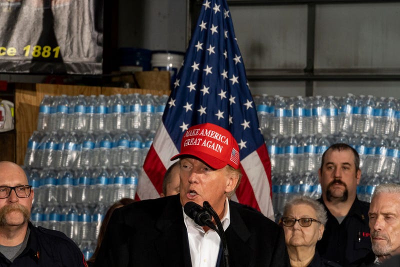 Former President Donald Trump stands next to a pallet of water before delivering remarks at the East Palestine Fire Department station on February 22, 2023 in East Palestine, Ohio. On February 3rd, a Norfolk Southern Railways train carrying toxic chemicals derailed causing an environmental disaster. Thousands of residents were ordered to evacuate after the area was placed under a state of emergency and temporary evacuation orders. (Photo by Michael Swensen/Getty Images)