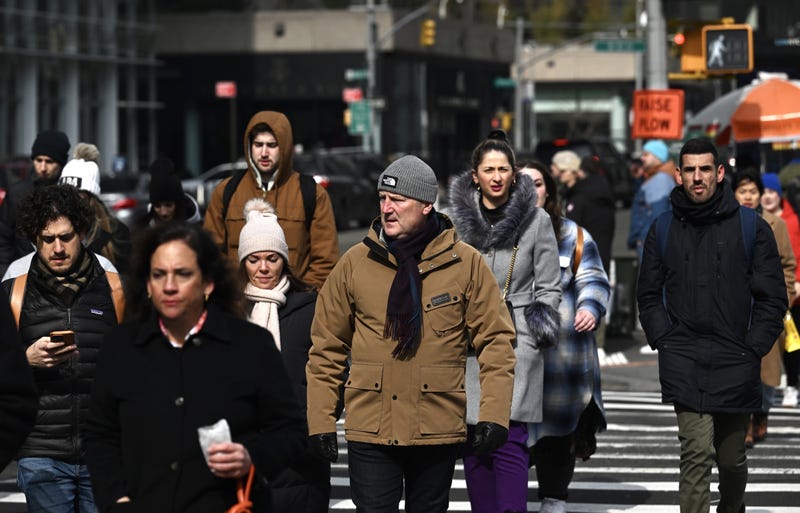 Pedestrians walk in Manhattan on a cold day