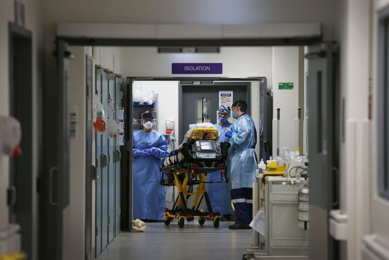 Emergency Medicine Specialist Dr Kevin Maruno and medical team take a suspected COVID-19 patient in to the isolation ward in the Red zone of the Emergency Department at St Vincent's Hospital on June 04, 2020 in Sydney, Australia.