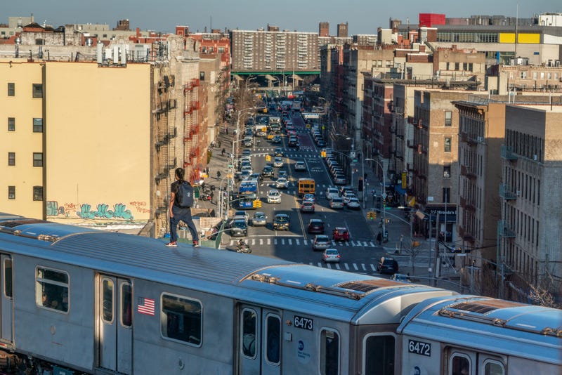 A person stands on a 5 train on March 16, 2023, in the Bronx