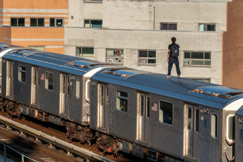 A person stands on a 5 train on March 16, 2023, in the Bronx