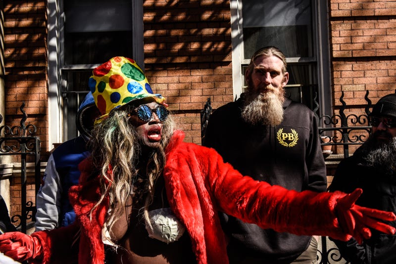 A performance artist stands near a Proud Boy outside of The Center, a support space for LGBTQ+ people on March 19, 2023 in New York City.