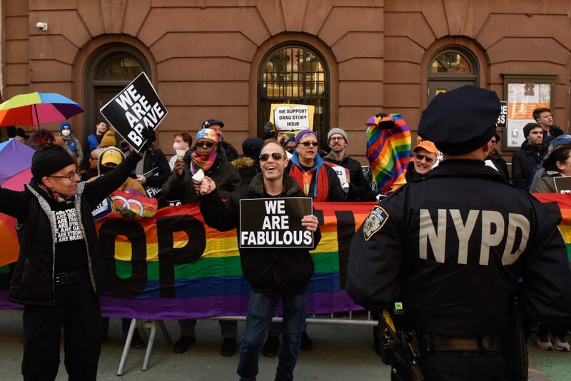 Protesters supporting Drag Queen story hour hold signs outside of The Center, a support space for LGBTQ+ people on March 19, 2023 in New York City.