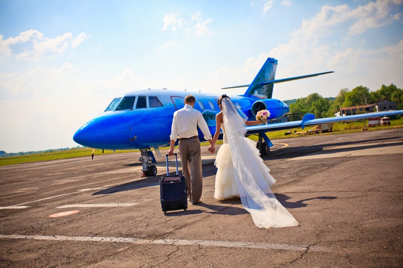 Wedding couple are prepare to fly on a honeymoon trip