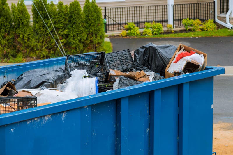 Man arrested after woman's body placed in dumpster 