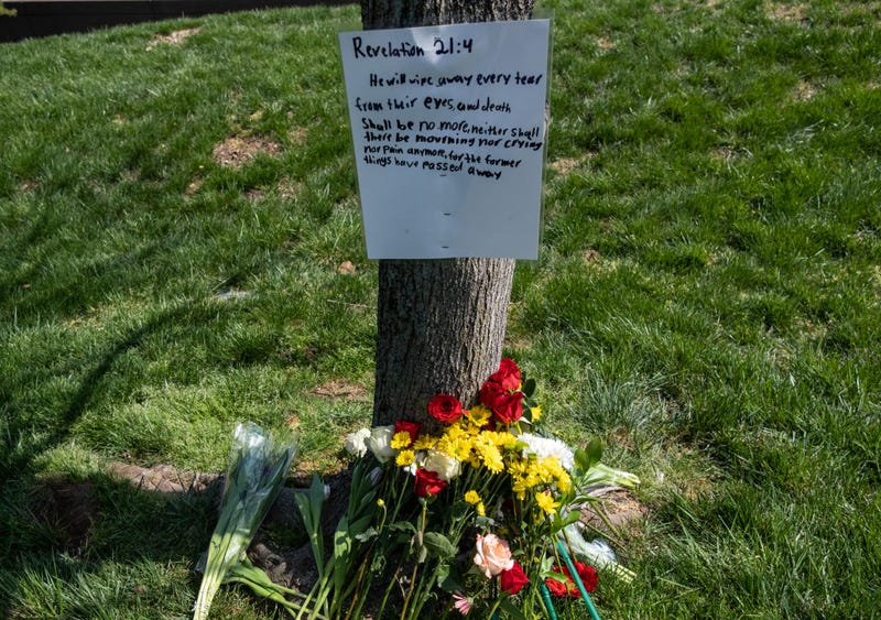 A scripture verse from the Bible and flowers in memory of those killed in a mass shooting are placed near The Covenant School on March 28, 2023 in Nashville, Tennessee.