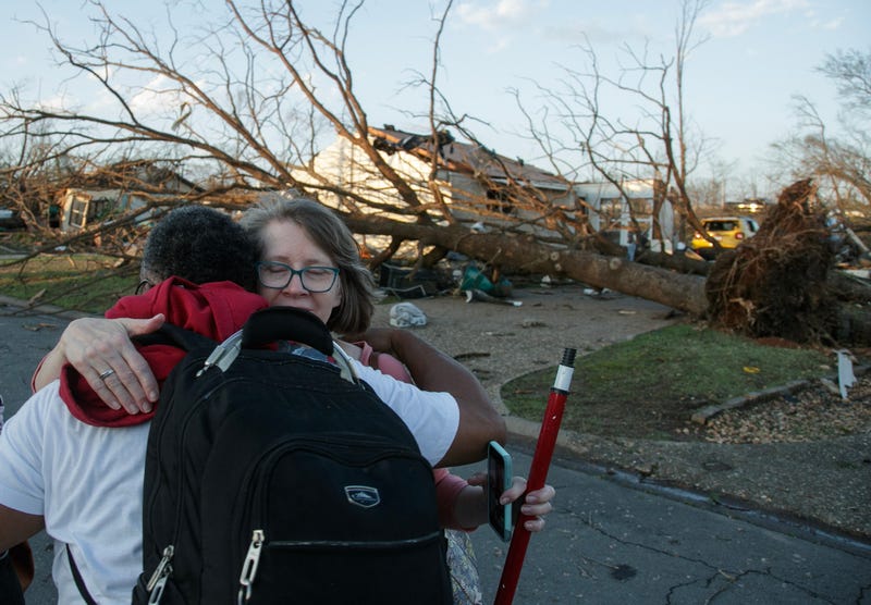 people hugging, tornado relief