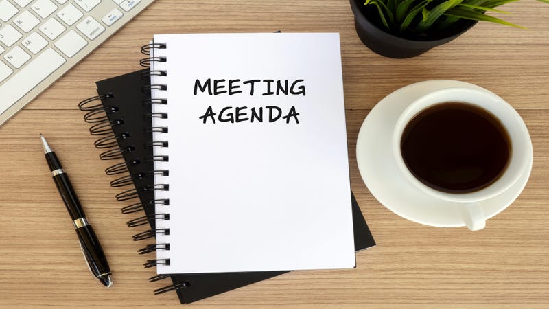 Meeting agenda text on note pad - stock photo
