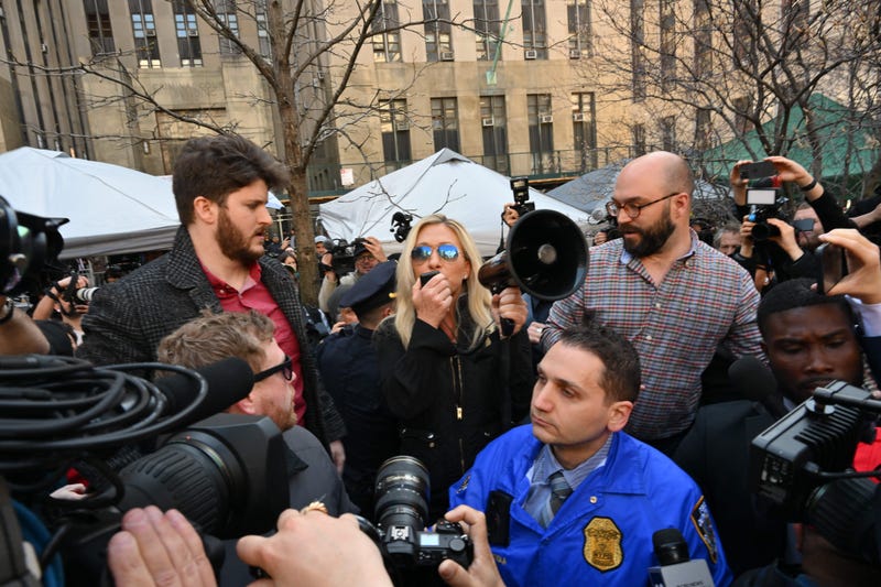 Rep. Marjorie Taylor Green (R-GA) talks to supporters of former President Donald Trump outside the District Attorneys office in New York on April 4, 2023