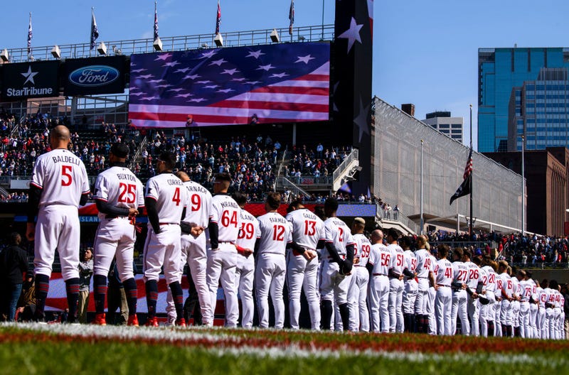 Minnesota Twins players line up for the National Anthem before the home opener against the Houston Astros at Target Field on April 7, 2023 in Minneapolis, Minnesota. 