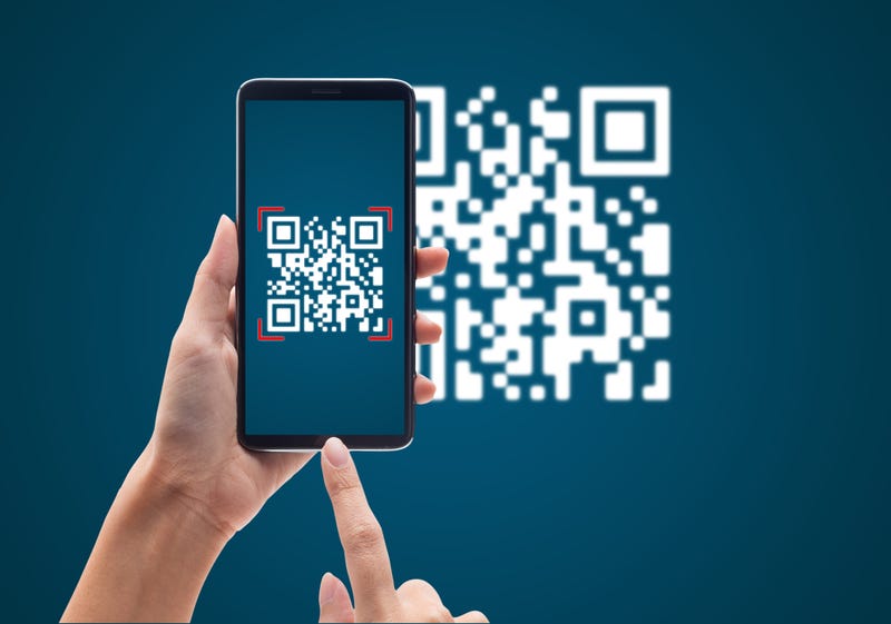 Someone using a mobile smart phone to scan a QR code.