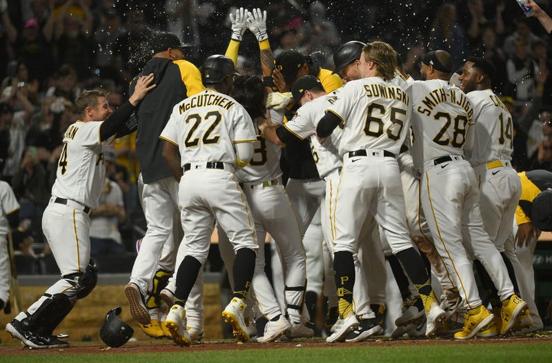 Ji Hwan Bae #3 of the Pittsburgh Pirates is mobbed by teammates after hitting a walk-off three-run home run for a 7-4 win over the Houston Astros at PNC Park