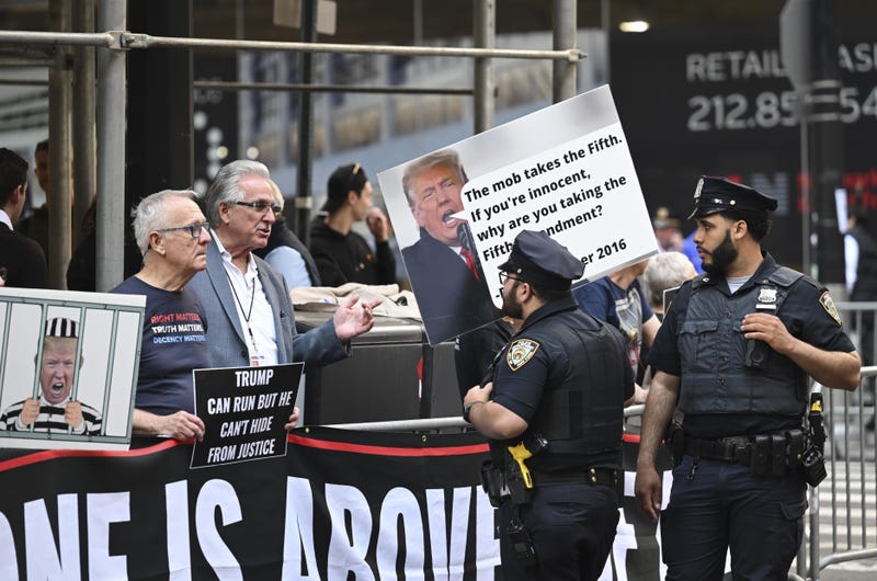 Anti-Trump protesters demonstrate near the attorney general's office on April 13, 2023