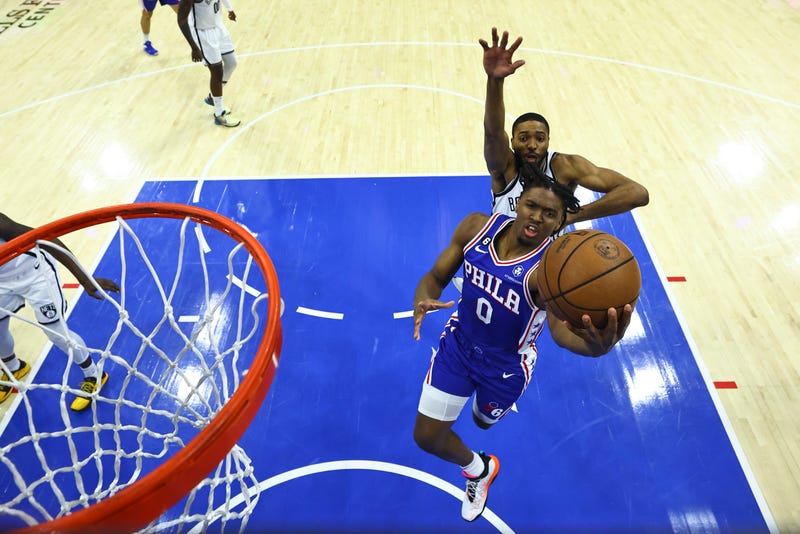 Tyrese Maxey, #0 of the Philadelphia 76ers, goes up for a layup against Mikal Bridges, #1 of the Brooklyn Nets, in the first quarter during Game 2 of the Eastern Conference first-round playoffs at the Wells Fargo Center on April 17, 2023, in Philadelphia, Pennsylvania.