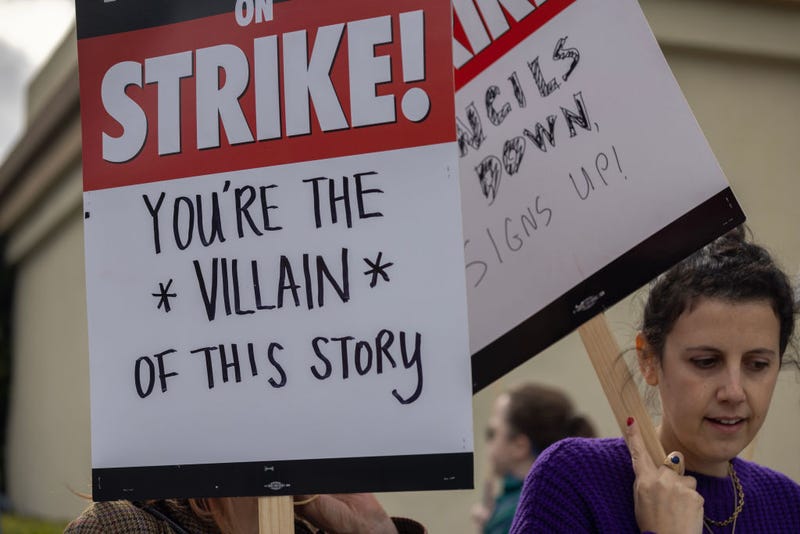 LOS ANGELES, CA - MAY 04: People picket outside of Paramount Pictures studios during the Hollywood writers strike on May 4, 2023 in Los Angeles, California. Scripted TV series, late-night talk shows, film and streaming productions are being interrupted by the Writers Guild of America (WGA) strike.