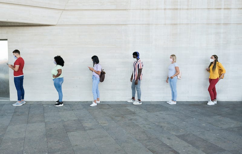 Multiracial people standing in a queue and waiting - Young people with social distancing and wearing protective face masks