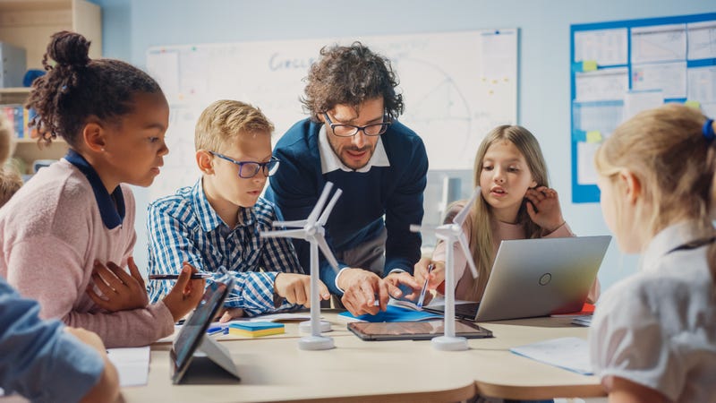 Stock image of science teacher with students