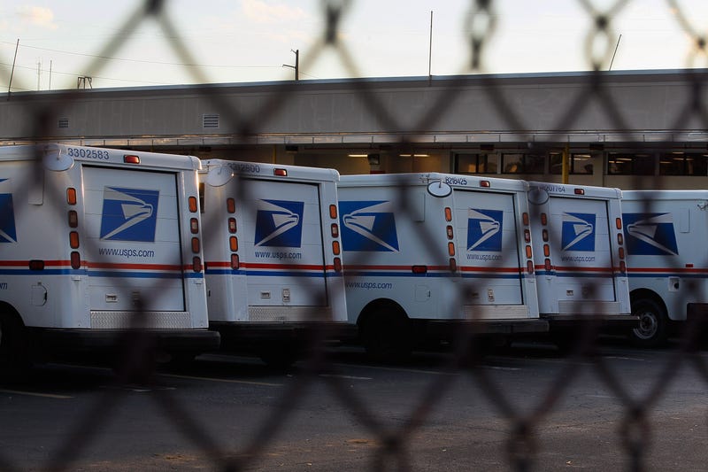 Mail trucks lined up at a Postal Service processing center