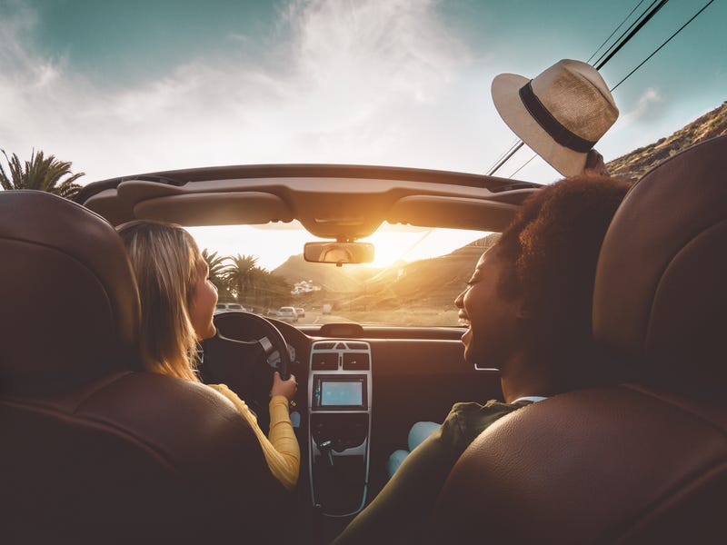 Two girls cruise on a tropical road