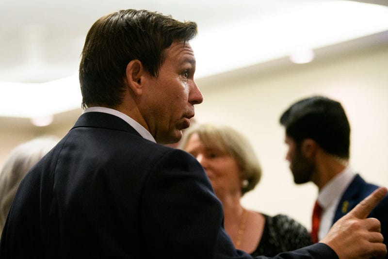 Florida Gov. Ron DeSantis speaks with attendees during an Iowa GOP reception on May 13, 2023 in Cedar Rapids, Iowa.