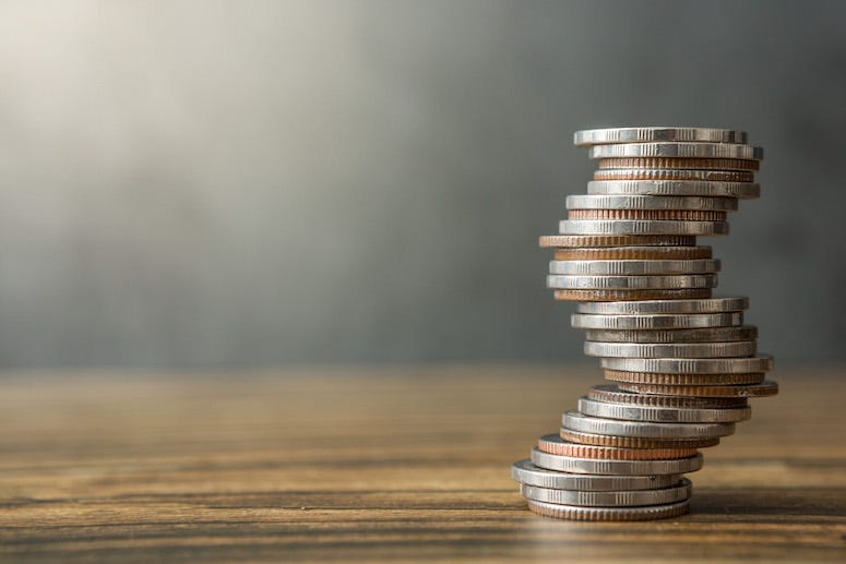 Stack of coins on wooden table