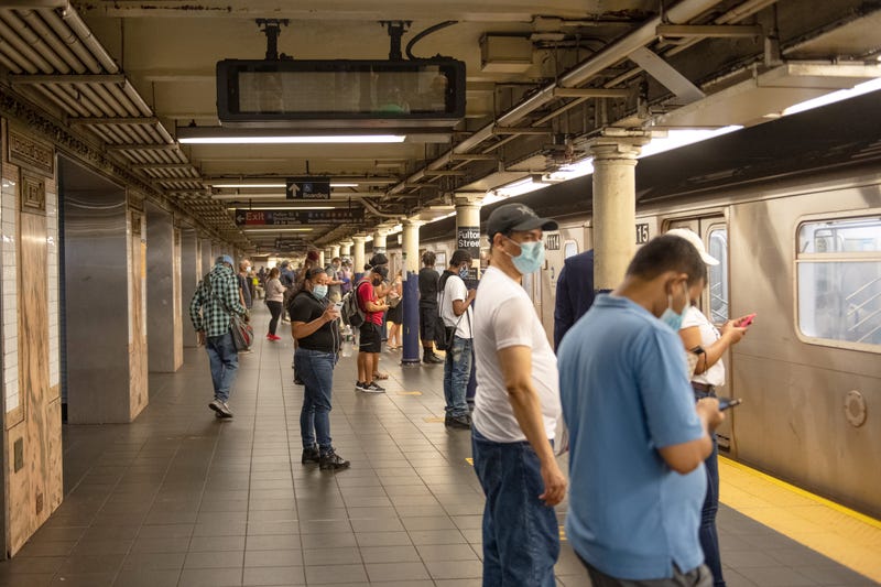 Straphangers wait for the subway at the Fulton Street station.