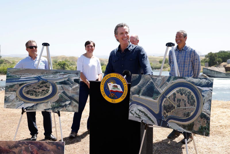 California Gov. Gavin Newsom (C) speaks to the media while displaying fishway renderings, as Willie Whittlesey, Yuba Water Agency General Manager (L-R), Cathy Marcinkevage, NMFS Assistant Regional Administrator, Chuck Bonham, CDFW Director, and Wade Crowfoot, CNRA Secretary listen in during a press conference at the Lower Yuba River and the Daguerre Point Dam on May 16, 2023 in Marysville, California.