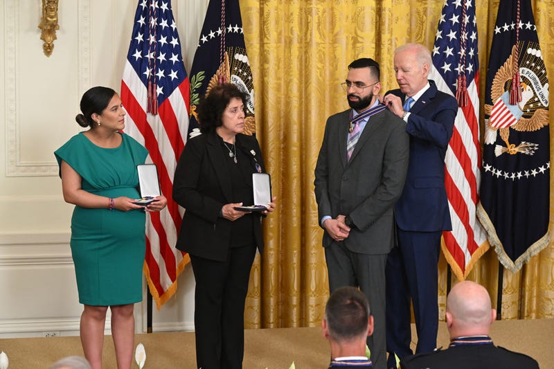 President Joe Biden awards the Medal of Valor to (L-R) Dominique Rivera, the wife of fallen NYPD Detective Jason Rivera; Gabina Mora, the mother of fallen NYPD Detective Wilbert Mora; and NYPD Detective Sumit Sulan in the East Room of the White House in Washington, DC, on May 17, 2023