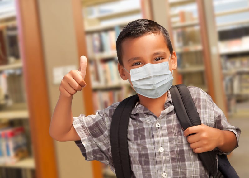 Elementary student wearing face mask amid COVID-19 pandemic