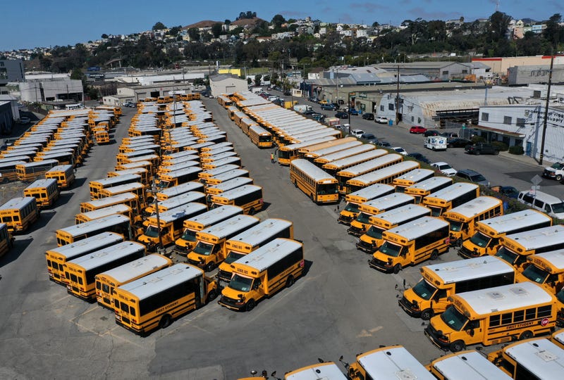 chool buses sit parked in a lot at First Student Charter Bus Rental on July 14, 2020 in San Francisco, California.