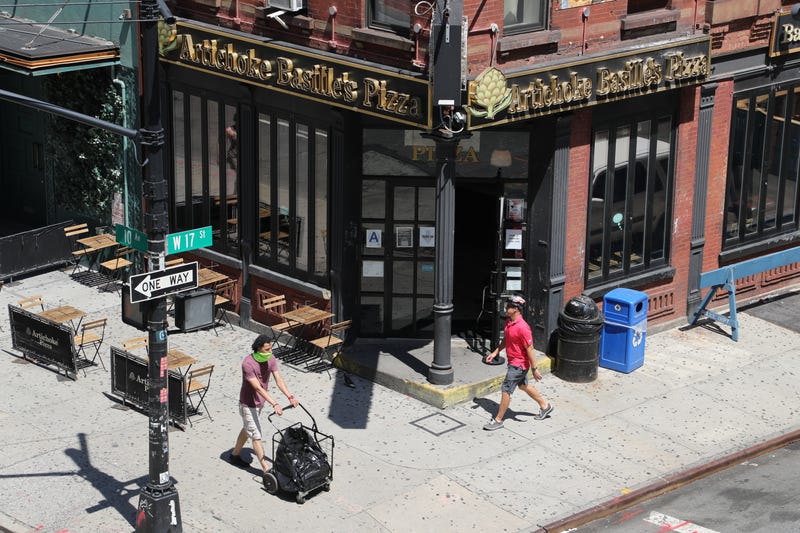 People walk by Artichoke Basille’s Pizza in the Meatpacking District on July 18, 2020.