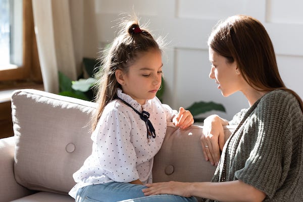 Mother talking to young daughter