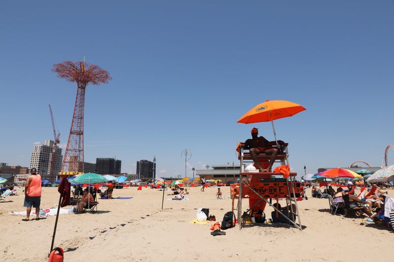 HeatA life guard sits in the chair as people visit the beach at Coney Island in Brooklyn