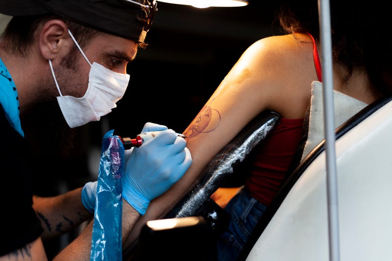 woman getting tattoo