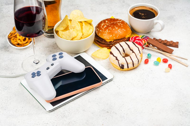 Stock photo of addictive items -- coffee, food, alcohol, tablets. 
