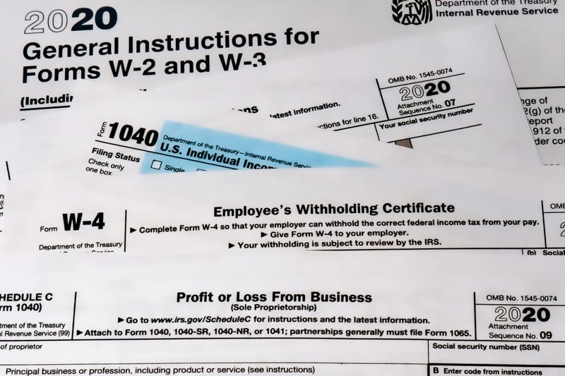 Various 2020 US IRS tax forms on a desktop